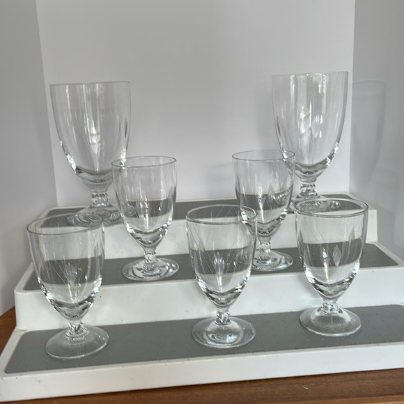 Set of 7 Art Deco floral etched crystal footed drinking glasses.